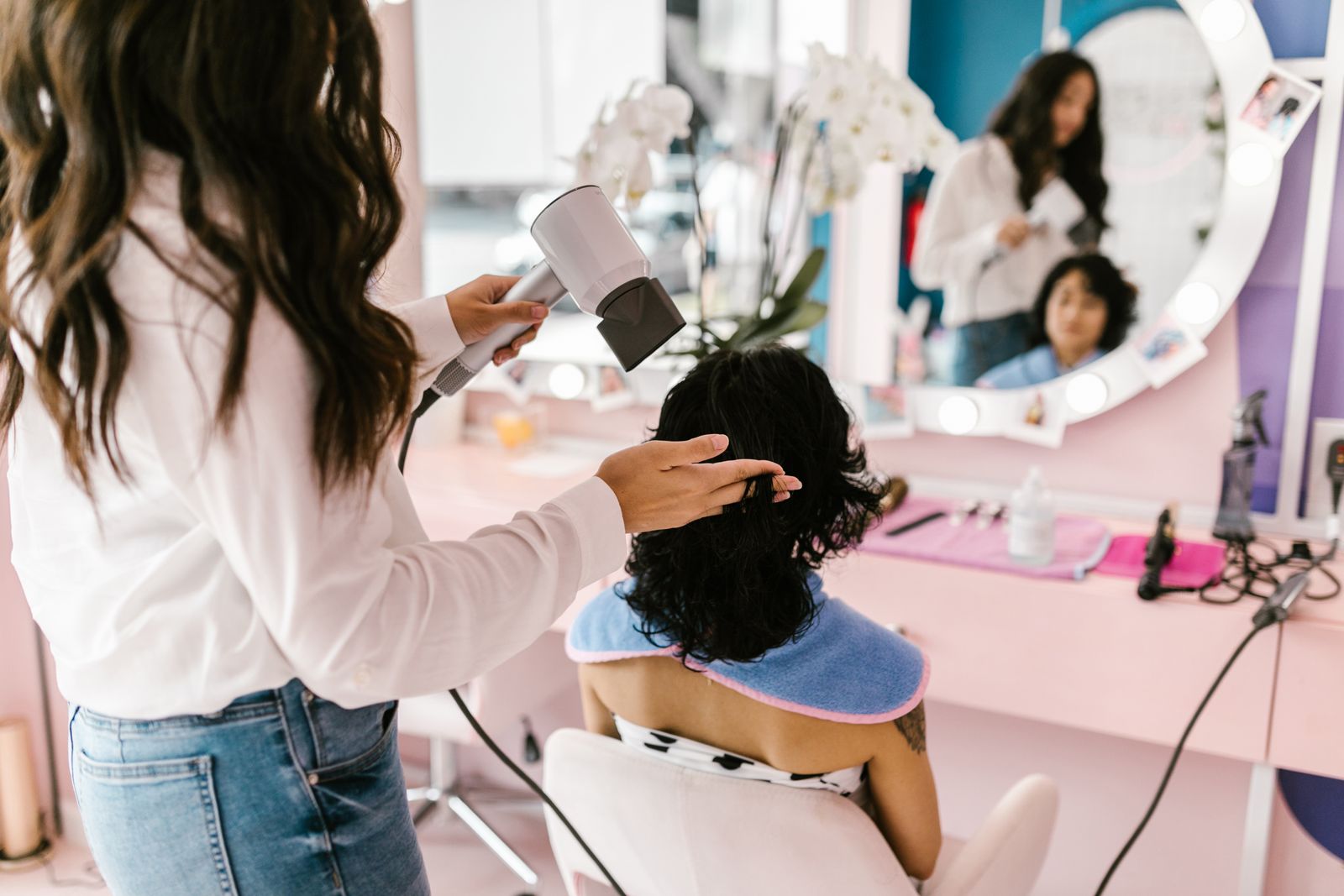 Hairdresser blow-drying a client’s hair