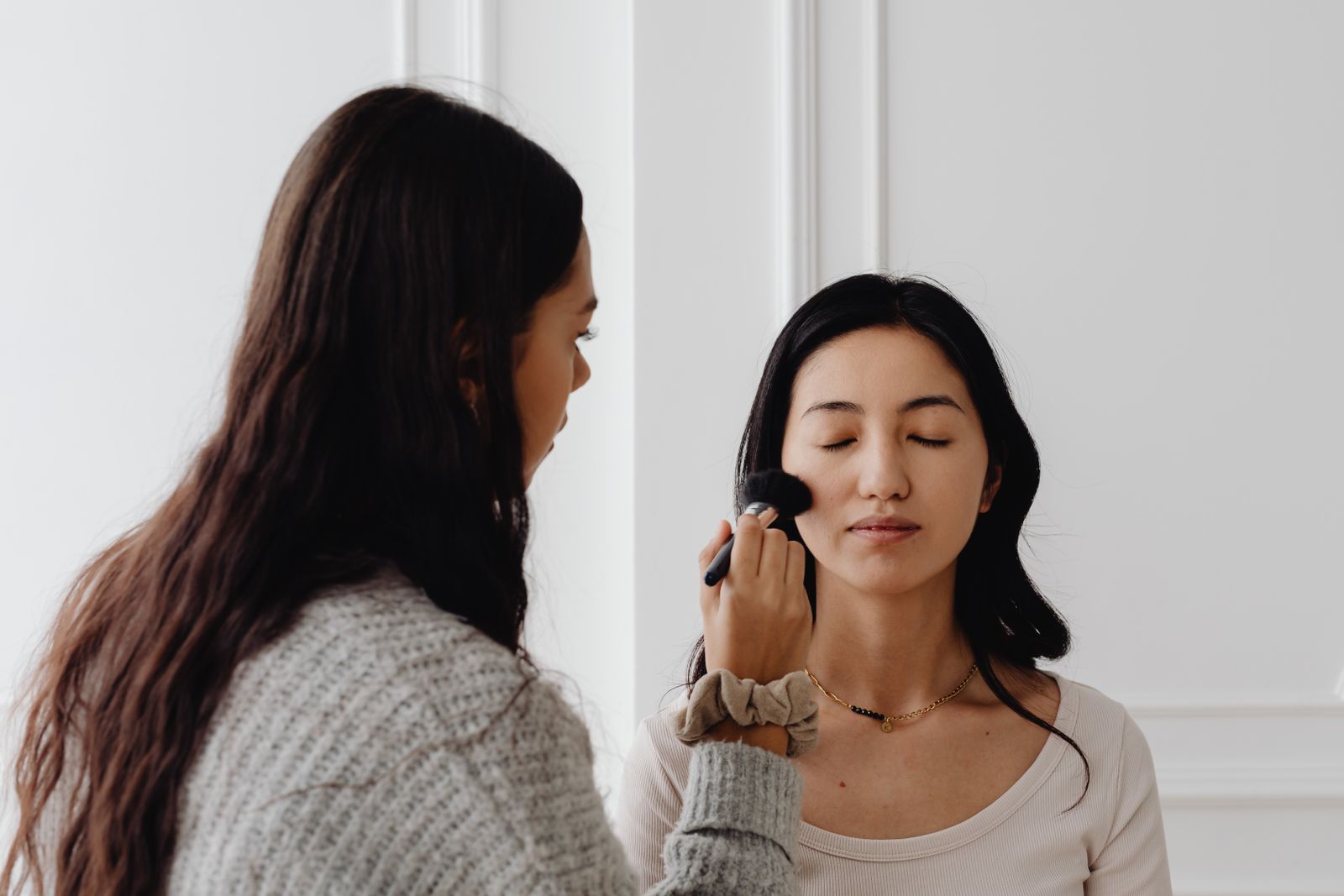 Makeup artist applying makeup to a client